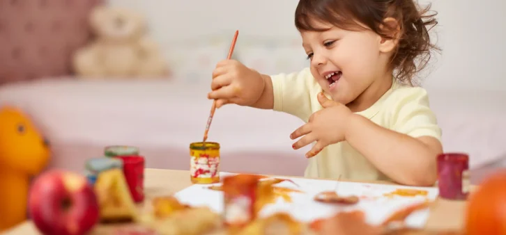 child-girl-painting-on-autumn-yellow-leaves-with-g-2024-09-27-23-36-36-utc